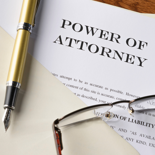 Power of Attorney document with pen and glasses laying on top if it