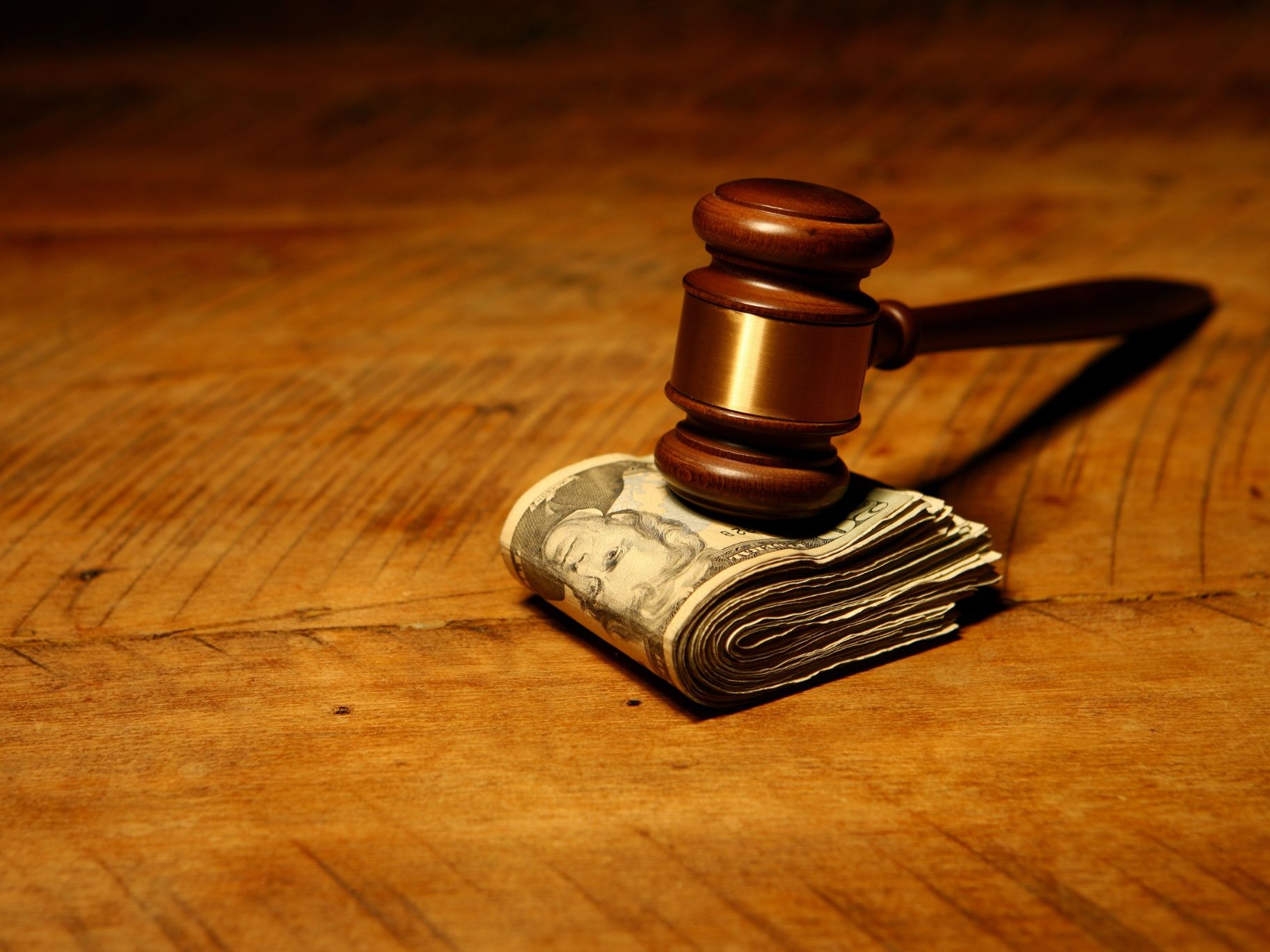 Gavel resting on a pile of money