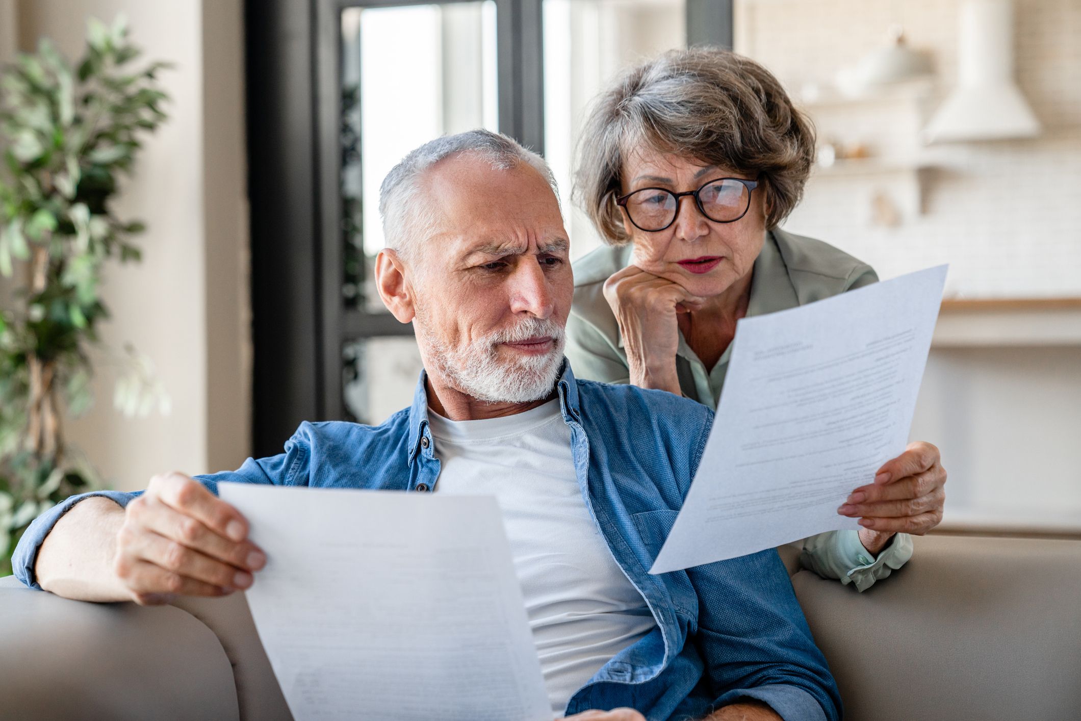 Senior adult spouses grandparents reading documents, estate planning & elder law