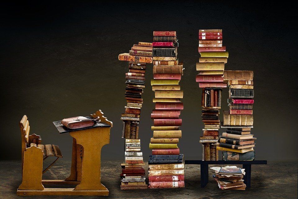 Piles of study books in a dark room