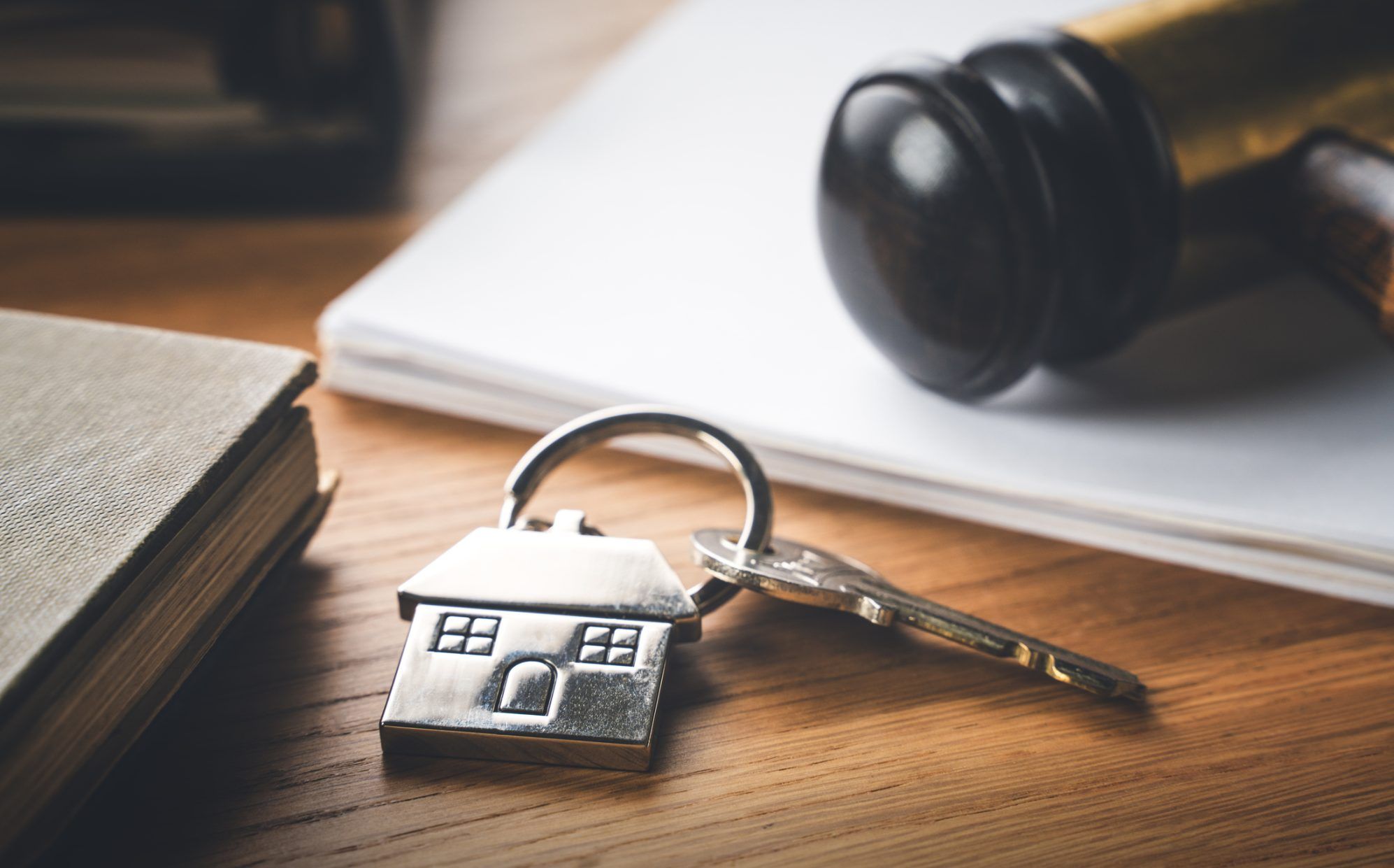 Gavel and house key on the table